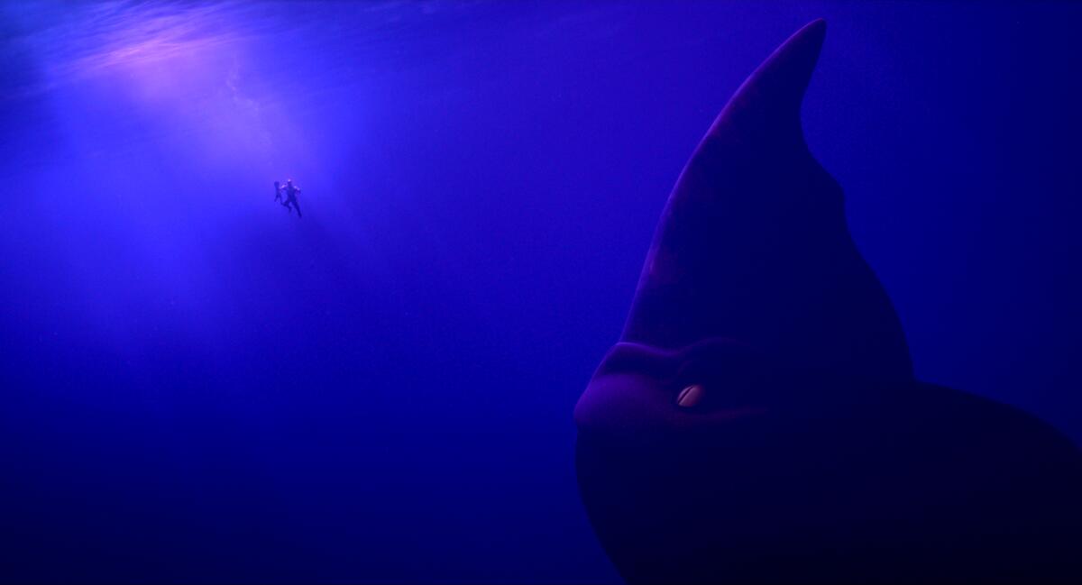 A man and a young girl, underwater, encounter a titanic sea monster 