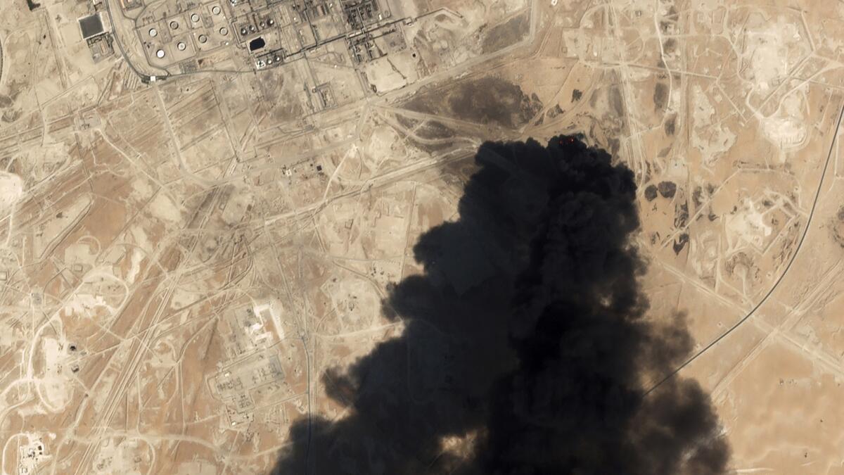 A satellite image shows thick black smoke rising from Saudi Aramco's Abqaiq oil processing facility in Buqyaq, Saudi Arabia, on Saturday.