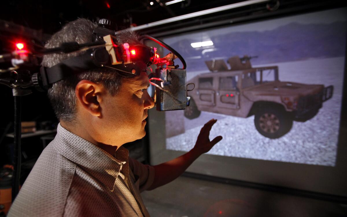 Mark Bolas, director of the Mixed Reality Lab at USC's Institute for Creative Technologies, reaches out while wearing a virtual reality headset at a university building in Playa Vista.