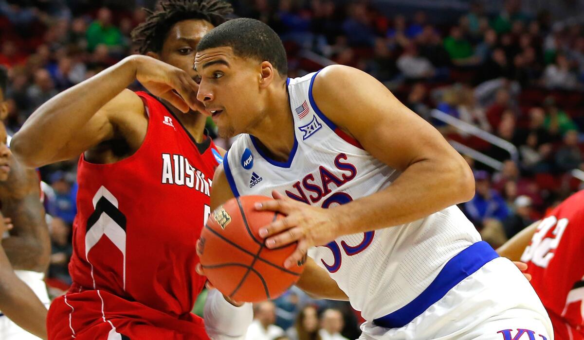 Kansas forward Landen Lucas drives to basket against Austin Peay forward Chris Horton on Thursday.