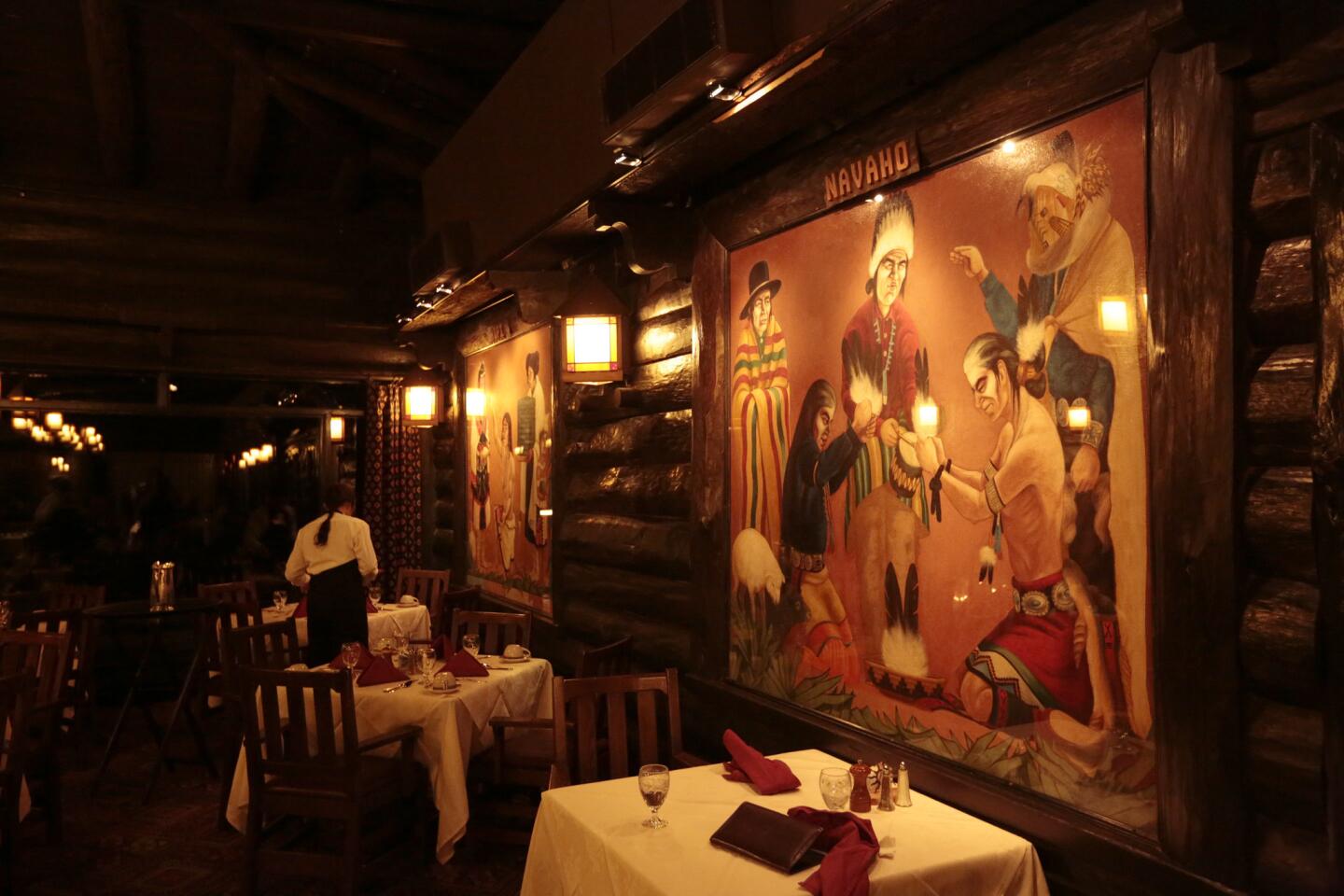 The dining room of the El Tovar Hotel is decorated with depictions of Native American culture.