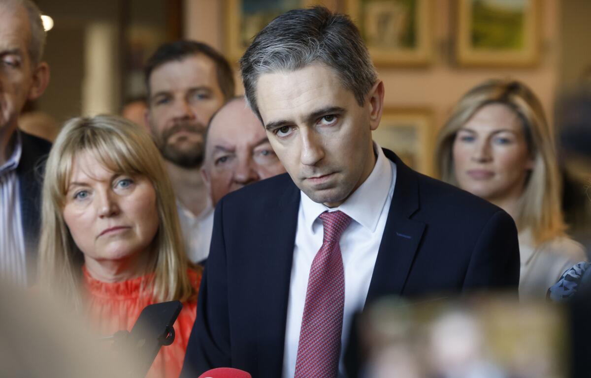 Minister for Further and Higher Education Simon Harris listens to a question during a press conference.