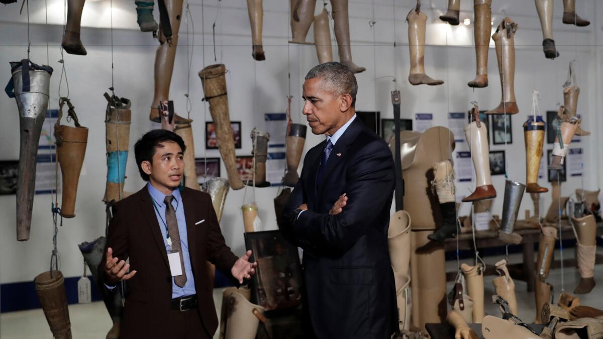 President Obama tours the Cooperative Orthotic and Prosthetic Enterprise center in Vientiane, Laos, on Wednesday.