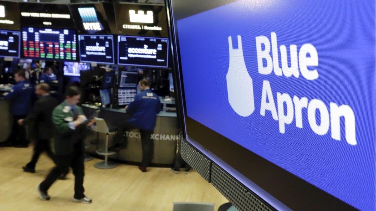 The logo for Blue Apron appears on a screen above the trading floor of the New York Stock Exchange in October 2017.
