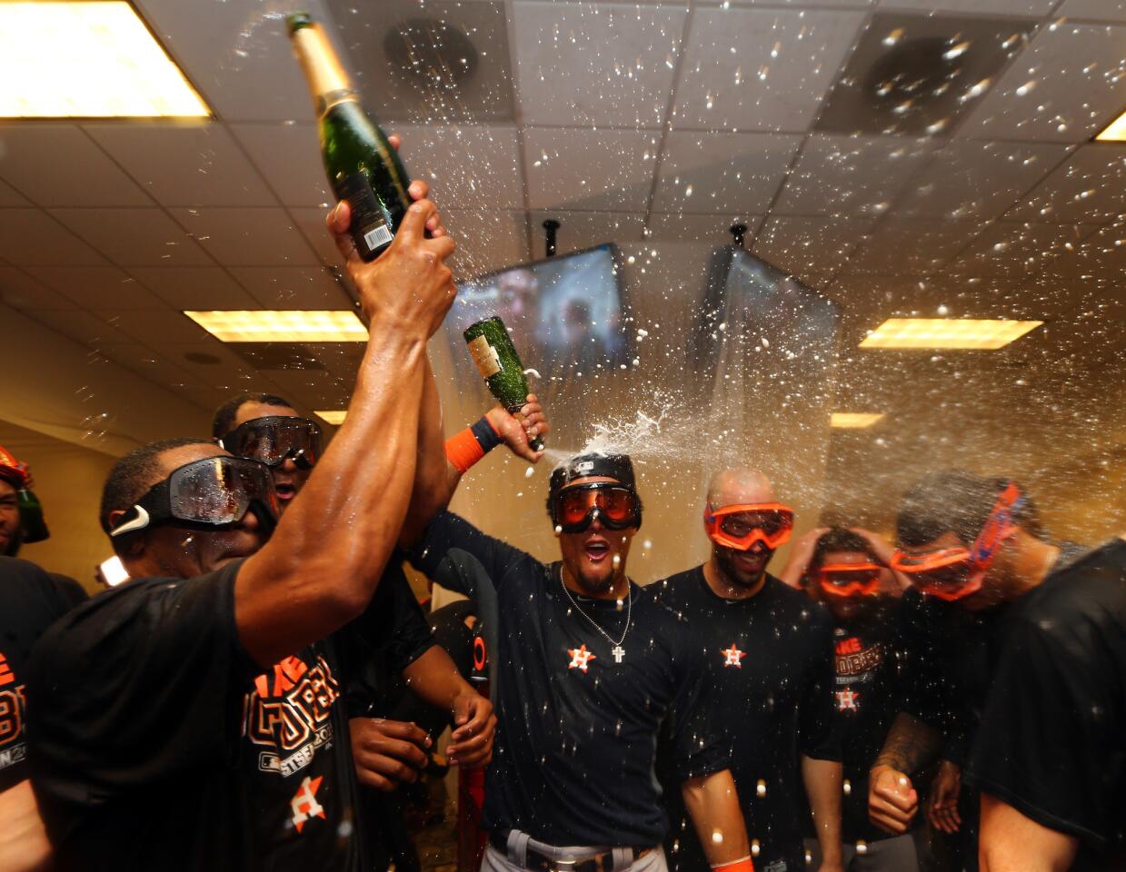 NEW YORK, NY - OCTOBER 06: The Houston Astros celebrate in their locker room after defeating the New York Yankees in the American League Wild Card Game at Yankee Stadium on October 6, 2015 in New York City. The Astros defeated the Yankees with a score of 3 to 0. (Photo by Elsa/Getty Images) ** OUTS - ELSENT, FPG, CM - OUTS * NM, PH, VA if sourced by CT, LA or MoD **