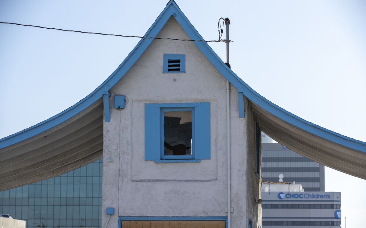 The tiny building is painted with distinctive blue trim.