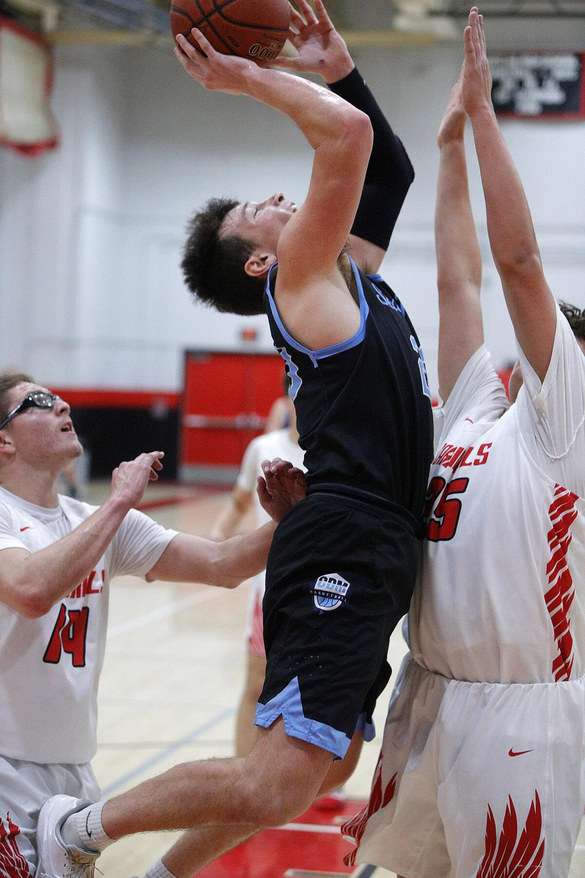 Corona del Mar's Jack Stone drives and leans back to shoot against Whittier's Jaime Albarran in a Artesia Winter Classic pool-play game on Wednesday in Lakewood.