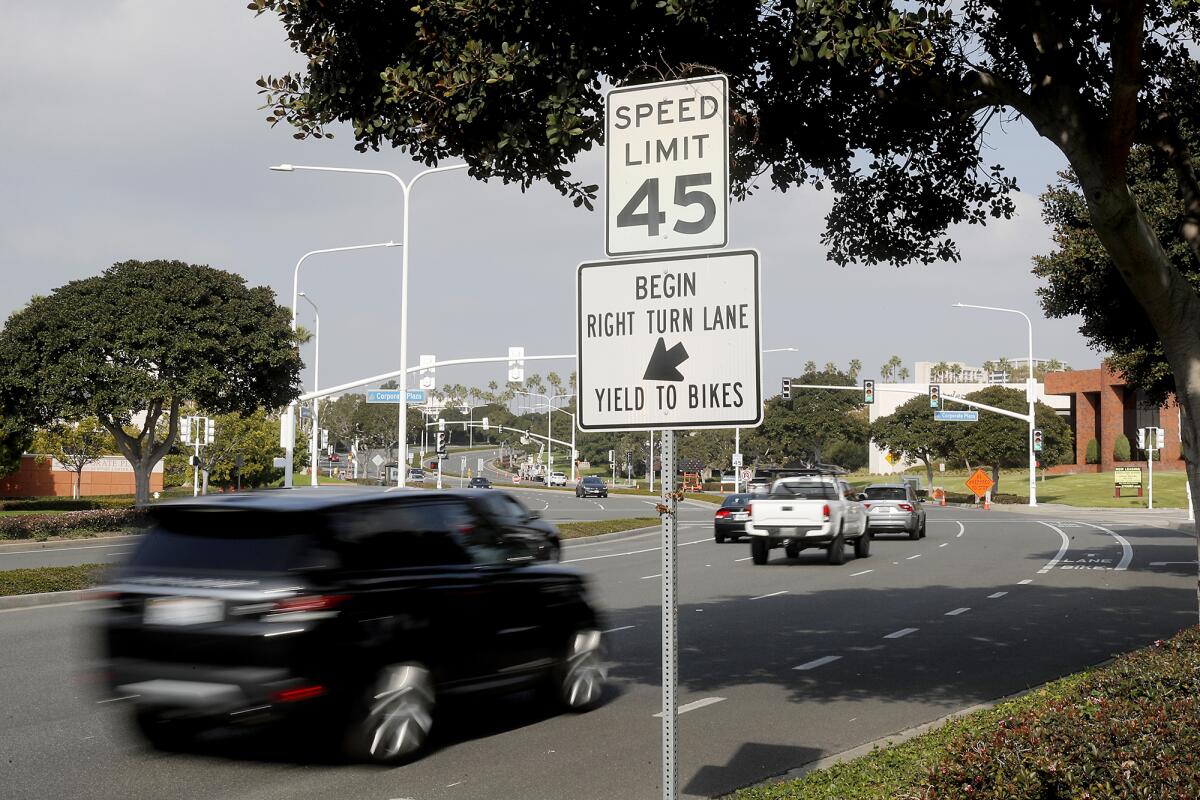Traffic moves along Newport Center Drive toward Fashion Island in Newport Beach on Tuesday. The city will lower the speed limit on that segment of the street from 45 to 40 mph.