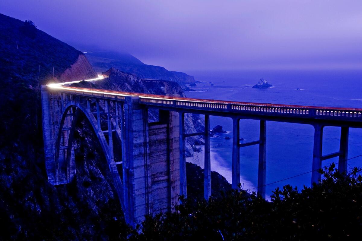DeAratanha, Ricardo -- - BIG SUR, CA - AUGUST 08, 2009 - Time exposure showing the traffic on Pacific Coast Highway going over the Bixby Historic Bridge in Big Sur, August 8, 2009. This bridge, built in 1932, is one of the most photographed bridges in the world. Photo to illustrate a TRAVEL story with the home and stomping grounds of author Robinson Jeffers as a guide for the story.