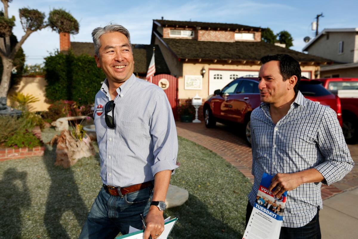 Al Muratsuchi, left, a Democrat running for state Assembly in a crucial South Bay swing district, and Assembly Speaker Anthony Rendon canvass a neighborhood in Torrance.