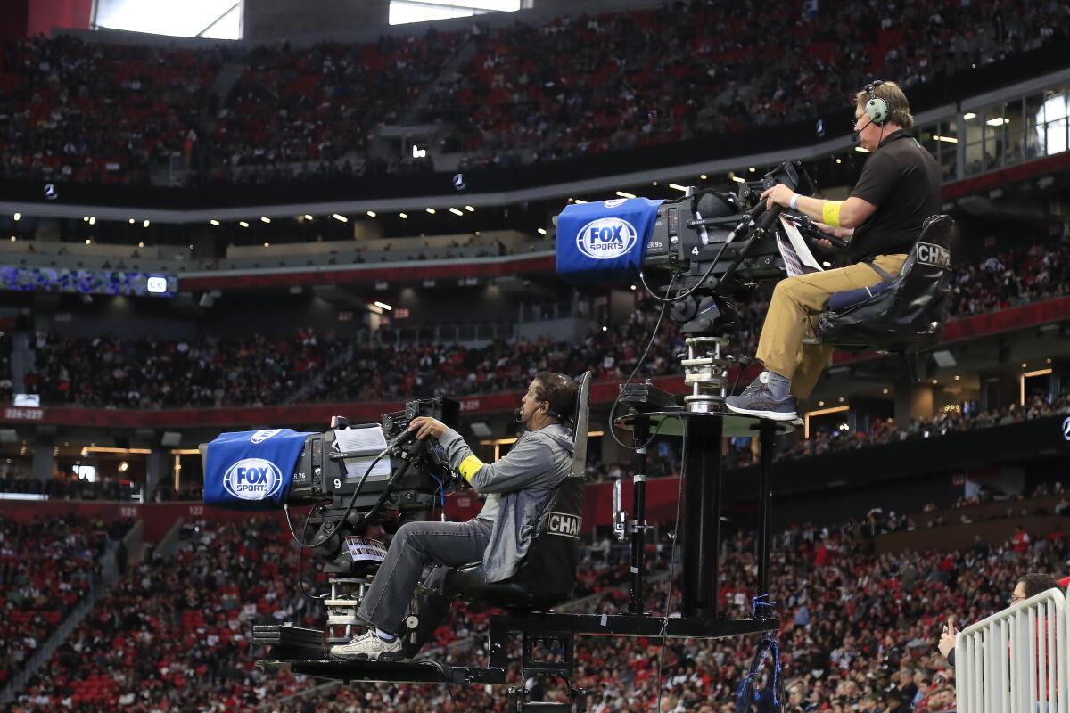 Fox Sports camera operators work during a game between the Tampa Bay Buccaneers and Atlanta Falcons.
