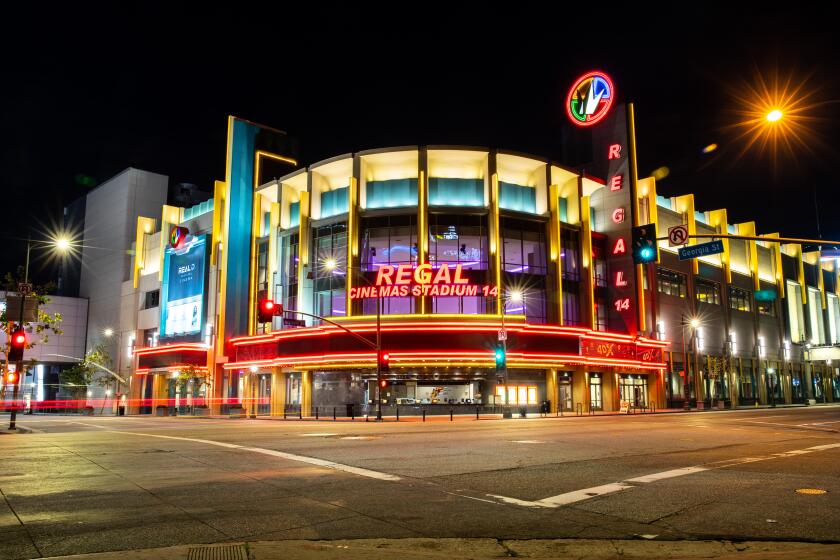 LOS ANGELES, CA --MARCH 21, 2020 -The Regal LA Live & 4DX theatre is lit up and empty at 8 p.m., in downtown Los Angeles, CA, on Saturday night, March 21, 2020. This was the first weekend night under California Gov. Gavin Newsom's "Safer at Home" mandate, which implored all Californians to stay home in an effort to slow the spread of the coronavirus. (Jay L. Clendenin / Los Angeles Times)