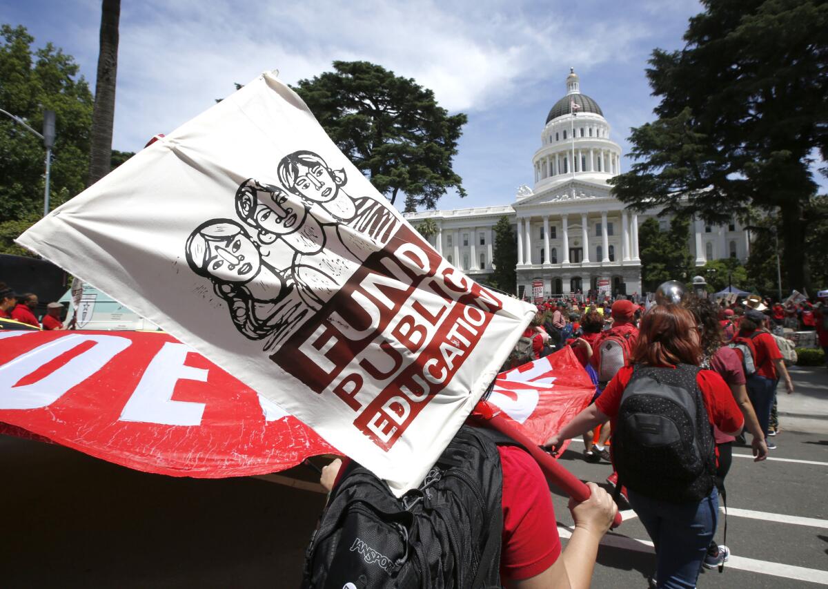 Members of the California Teachers Assn. and supporters of public education march to the Capitol as part of RedForEd Day of Action on May 22 in Sacramento to call on lawmakers to increase funding for public schools.