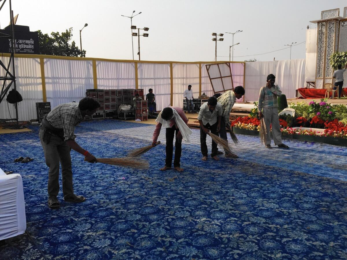 At Islam Gymkhana in Mumbai, India, workers toil to ready the site of a huge wedding reception.