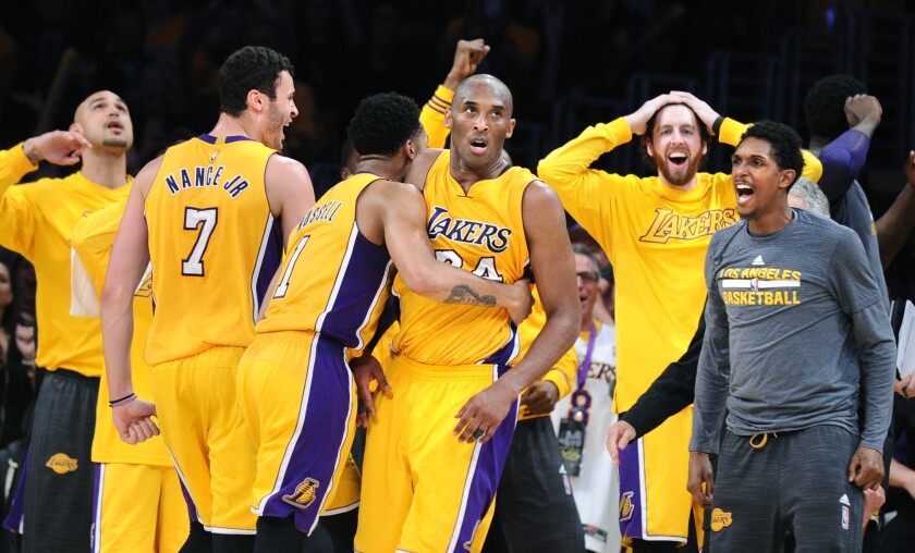 Lakers star Kobe Bryant is mobbed by teammates during his 60-point farewell game on April 13, 2016, at Staples Center.