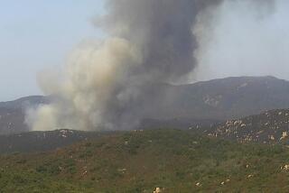 In this image from an AlertCalifornia/UC San Diego monitoring camera, the Tenaja fire in Riverside county near the Tenaja Truck Trail in the Cleveland National Forest, authorities said. It was mapped at 100 acres as of 1:45 p.m.