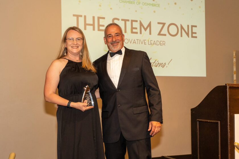 Carrie Herndon of The STEM ZONE Maker Space poses with Chamber President Mike Leland and Innovative Leader Award. 