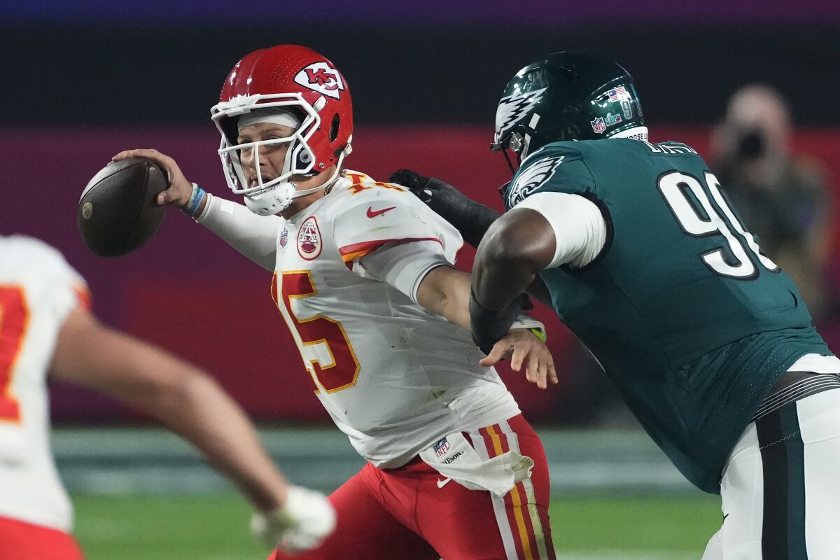 Kansas City Chiefs quarterback Patrick Mahomes passes under pressure from Philadelphia Eagles defensive tackle Jordan Davis.