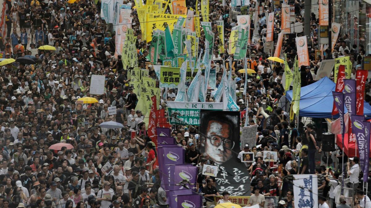 Protesters carry a large image of jailed Chinese Nobel Peace laureate Liu Xiaobo as they march during the annual pro-democracy protest in Hong Kong on Saturday.