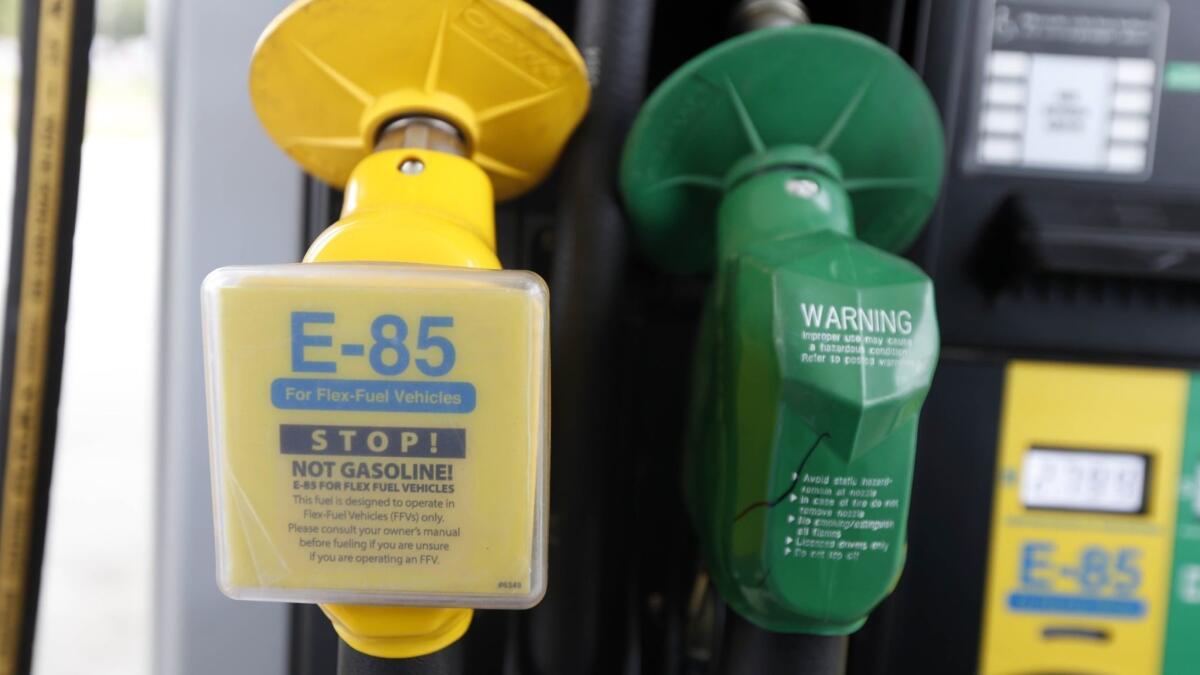 A fuel nozzle for E-85, left, and traditional gasoline is seen at a gas station in Batesville, Miss., in 2009.