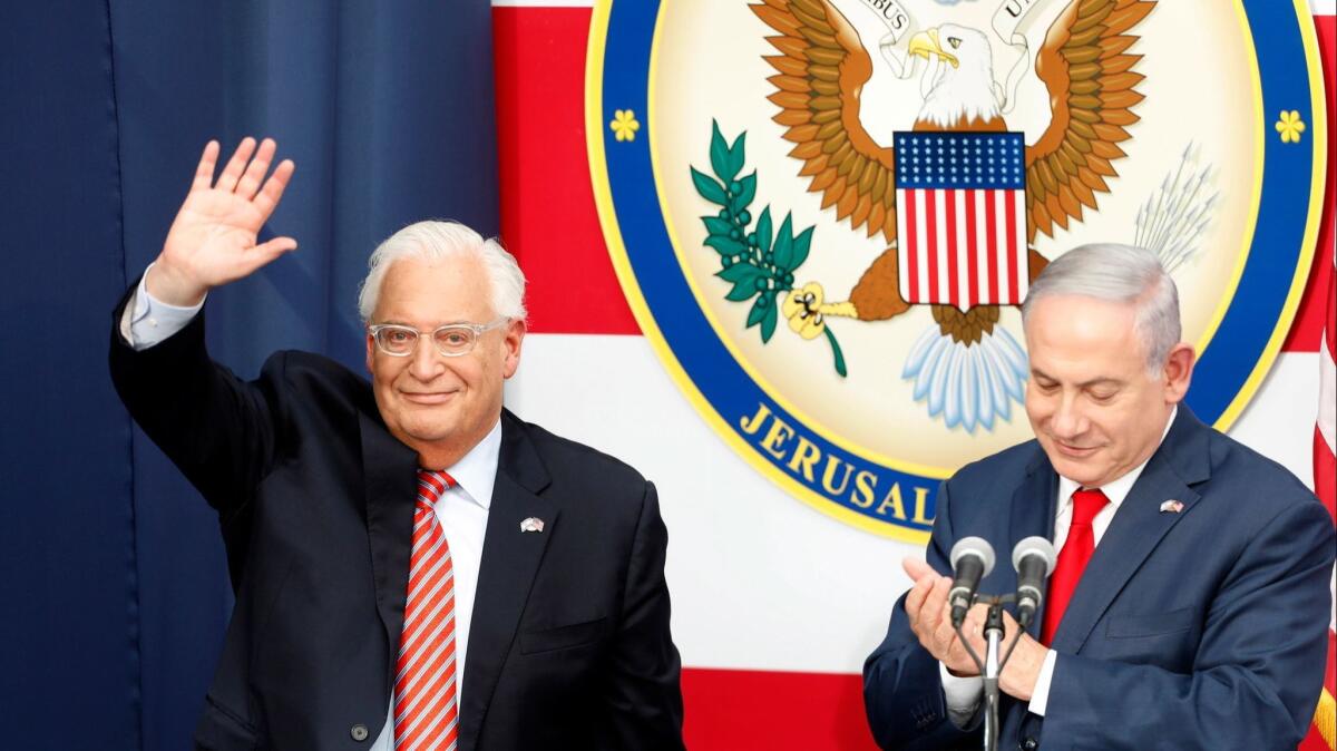 U.S. Ambassador to Israel David Friedman, left, waves as Israeli Prime Minister Minister Benjamin Netanyahu applauds during the opening ceremony at the U.S. consulate that will act as the new U.S. Embassy in the Jewish neighborhood of Arnona in Jerusalem in May 2018.