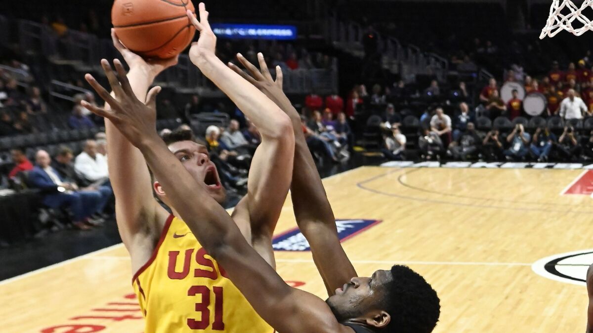USC forward Nick Rakocevic, left, shoots as TCU center Kevin Samuel defends during the first half of the Air Force Reserve Classic on Friday at Staples Center.