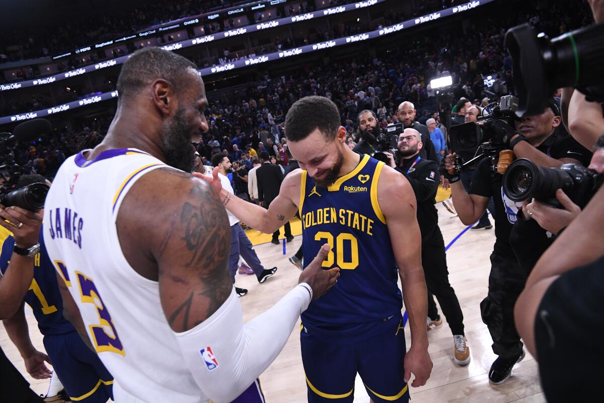 LeBron James shakes hands with Stephen Curry.