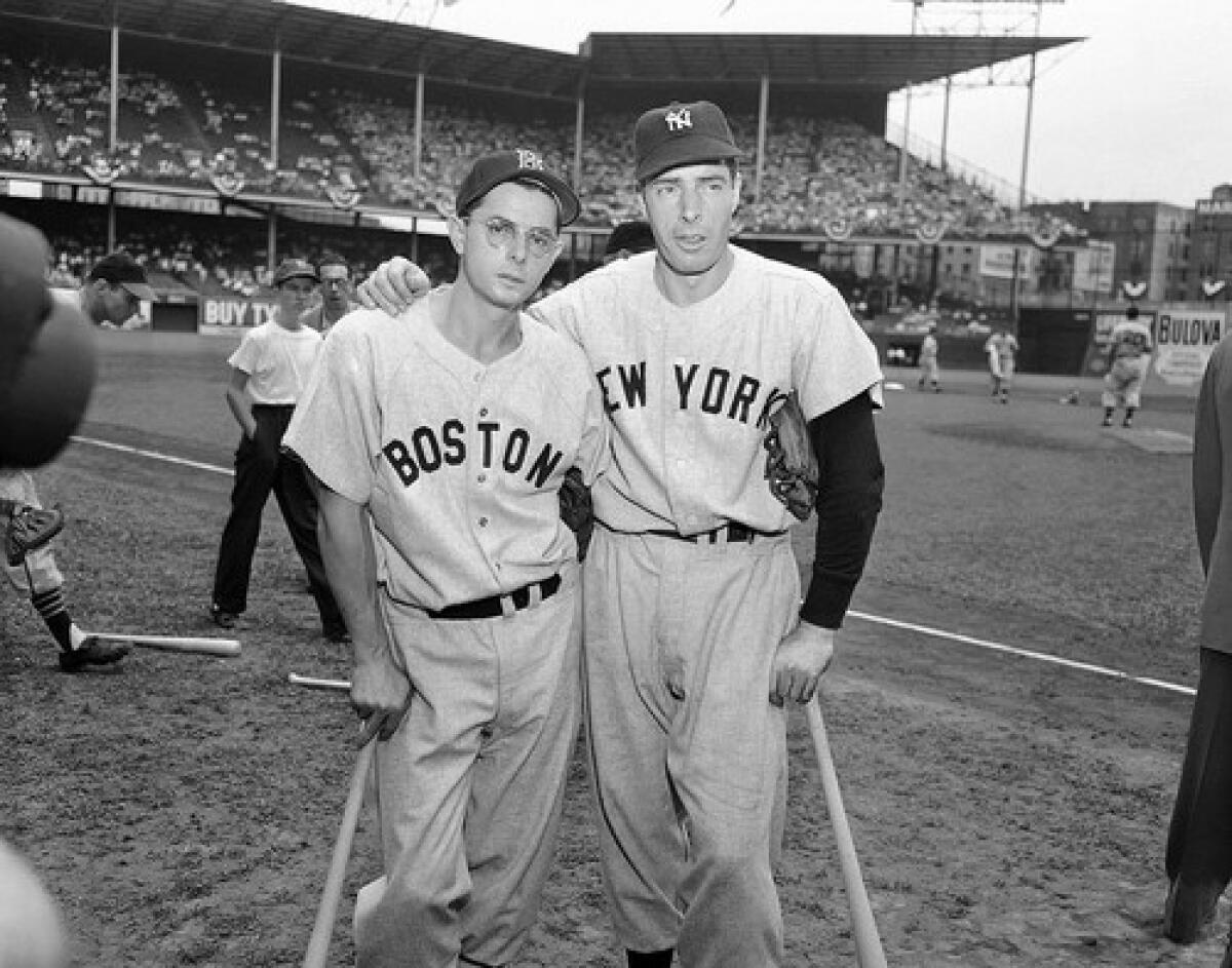 Dominic DiMaggio, left, seen in 1949, still holds the Boston Red Sox team record for the longest consecutive-game hitting streak, but was overshadowed by the towering legend of his brother Joe, the Yankee Clipper.