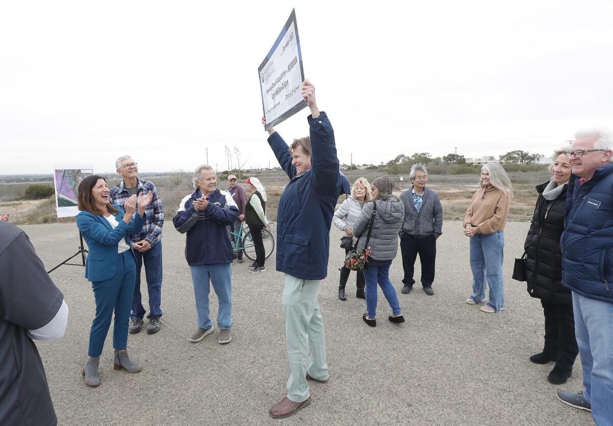 Banning Ranch Conservancy President Terry Welsh displays a donation from state officials.