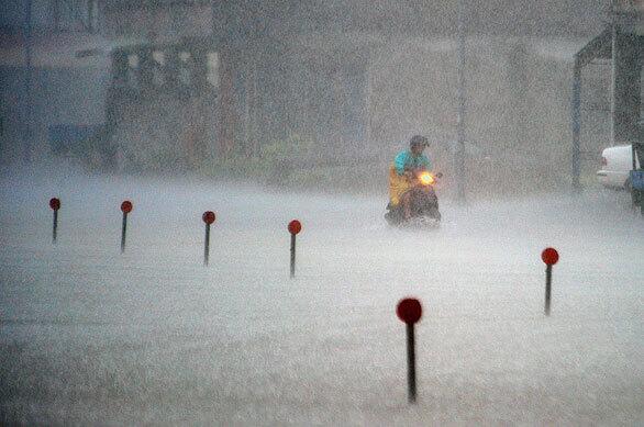 A man rides his scooter in heavy rains brought on by Typhoon Parma. Taiwan evacuated more than 6,000 people from their villages as the storm lingered near the island, bringing heavy rains and the risk of mudslides.