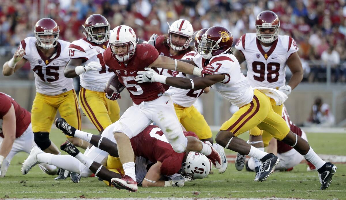Stanford's Christian McCaffrey (5) runs past USC's Marvell Tell III on Sept. 17.