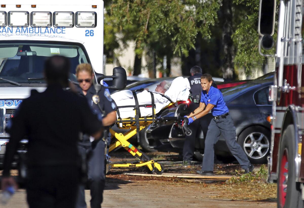 FILE - In this Wednesday, Sept. 13, 2017 file photo, a woman is transported from The Rehabilitation Center at Hollywood Hills as patients are evacuated after a loss of air conditioning due to Hurricane Irma in Hollywood, Fla. Defense attorneys said Sunday, August 25, 2019 that arrests are expected shortly in the case of a Florida nursing home where 12 elderly patients died after the complex lost power and was engulfed by sweltering heat during a powerful 2017 hurricane. (Amy Beth Bennett/South Florida Sun-Sentinel via AP, File)