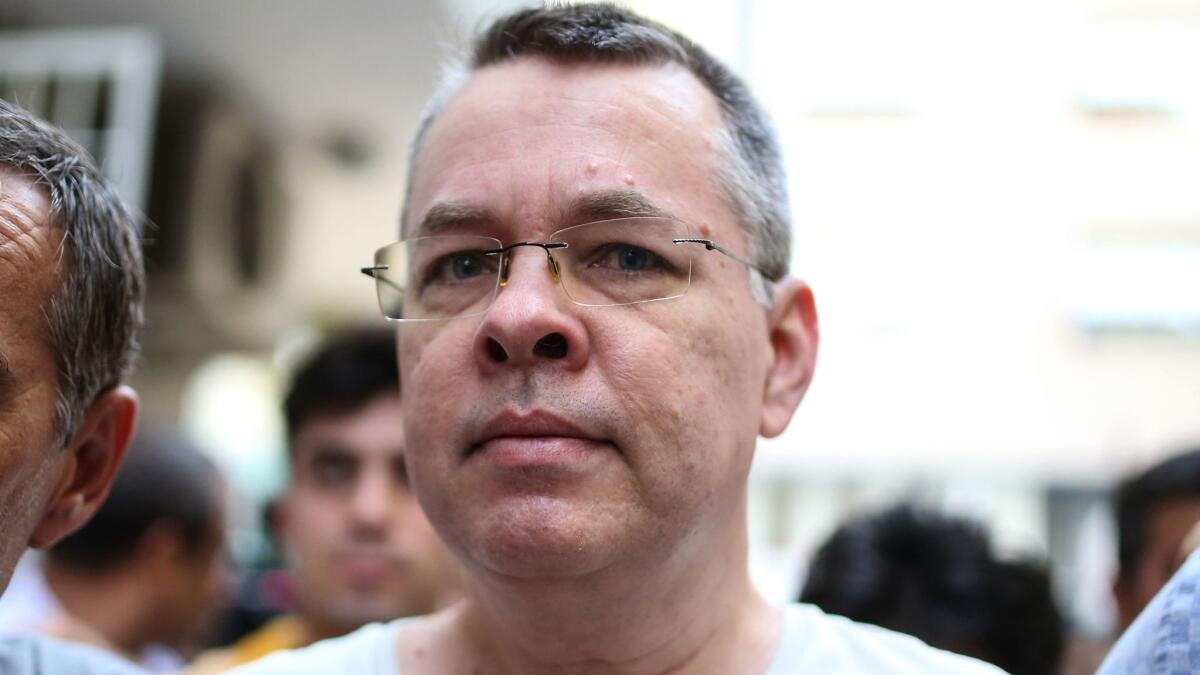 U.S. pastor Andrew Brunson is escorted by Turkish police officers to his house in Izmir.