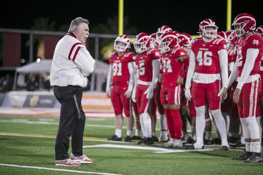  Mater Dei coach Bruce Rollinson gets the team ready before the game with San Mateo Serra