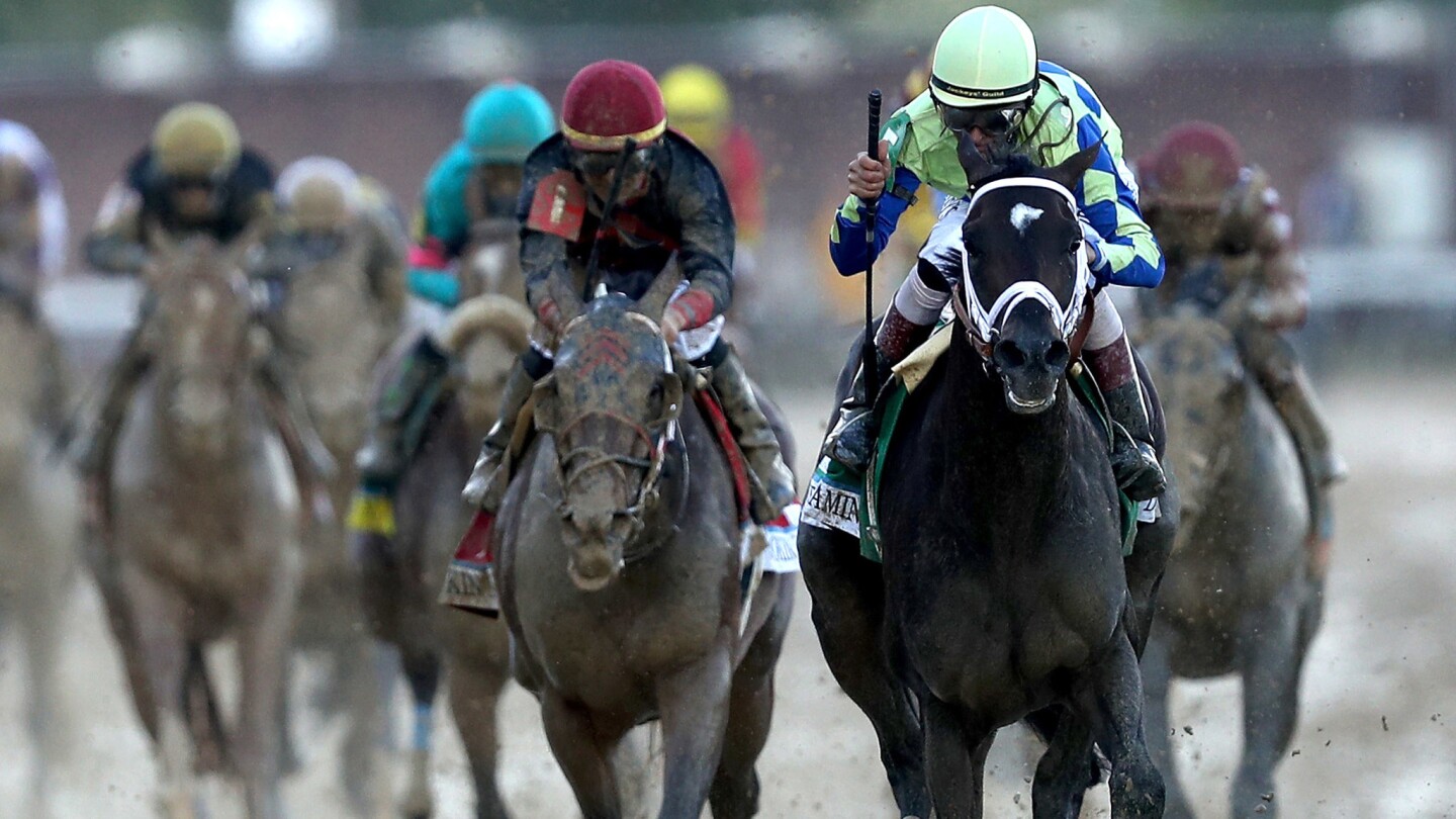 Jockey John Velazquez celebrates as he guides Always Dreaming across the finish line to win the 143rd running of the Kentucky Derby at Churchill Downs on Saturday.