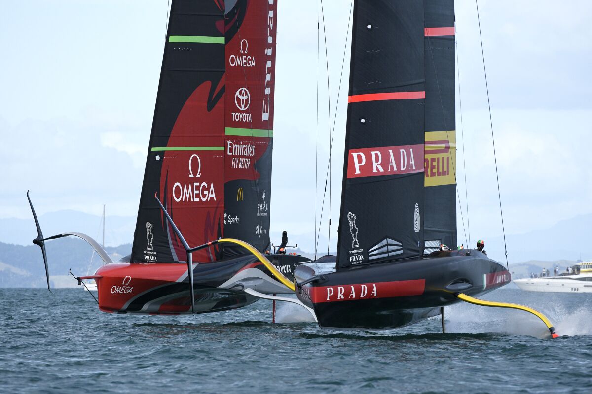 Italy's Luna Rossa, right, races Emirates Team New Zealand in race eight of the America's Cup on Auckland's Waitemata Harbour, Monday, March 15, 2021. (Chris Cameron/Photosport via AP)