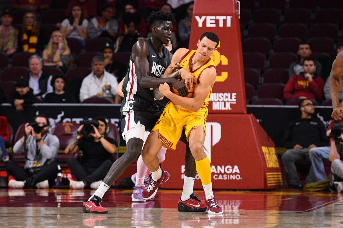 USC's Kobe Johnson, right, forces a jump ball against Washington State's Mouhamed Gueye on Feb. 2, 2023.