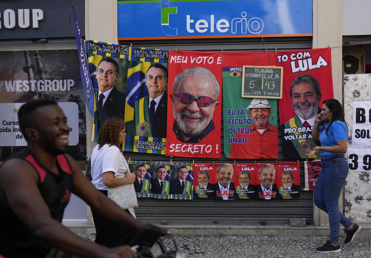 Towels featuring President Jair Bolsonaro and former President Luiz Inacio da Silva displayed on a street.