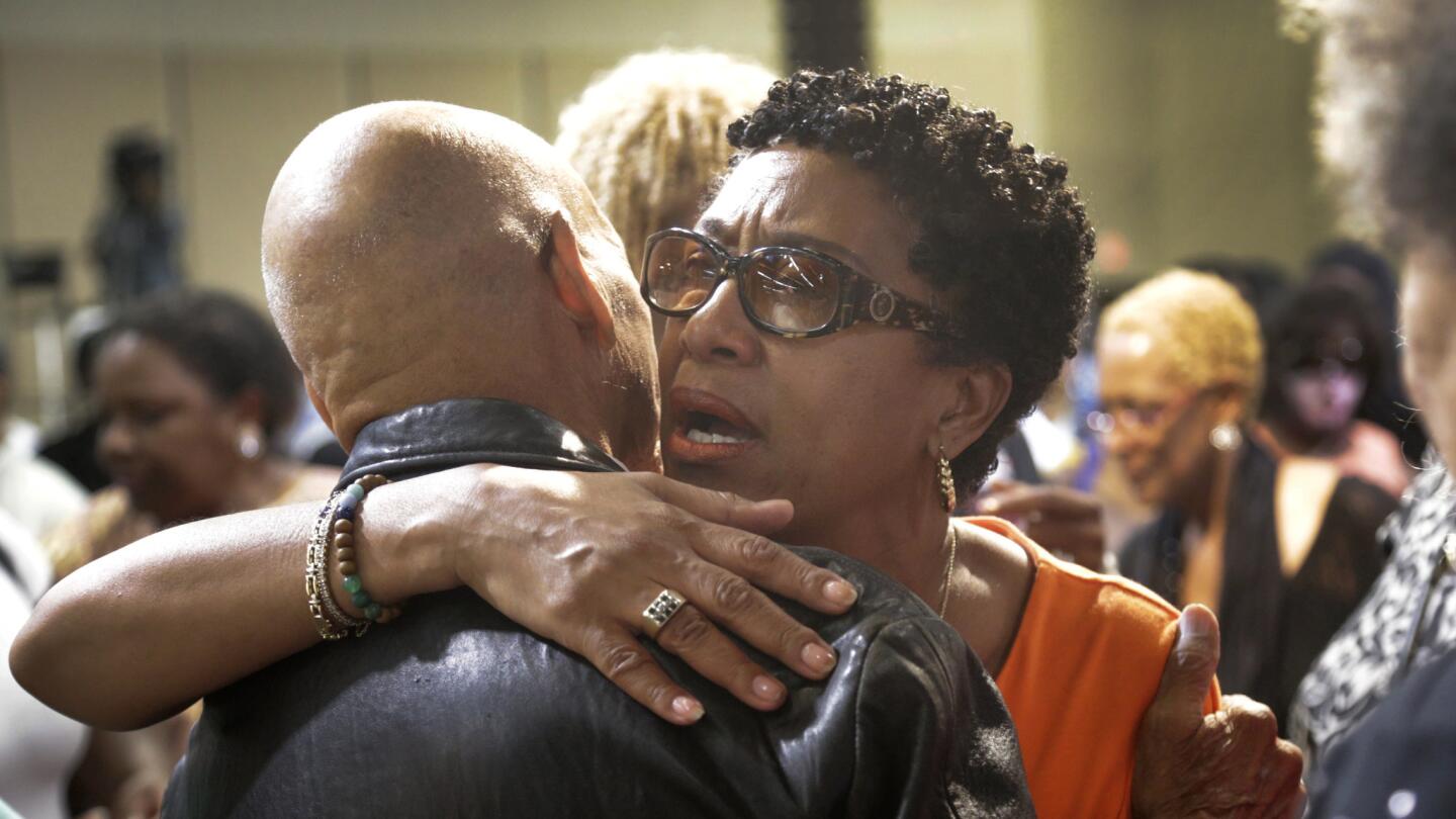 Norma Hollis, the former wife of Robert Hollis, is consoled at the vigil at Faithful Central Bible Church in Inglewood. Though they had divorced, the couple remained close, and Norma called Robert her "soul mate."