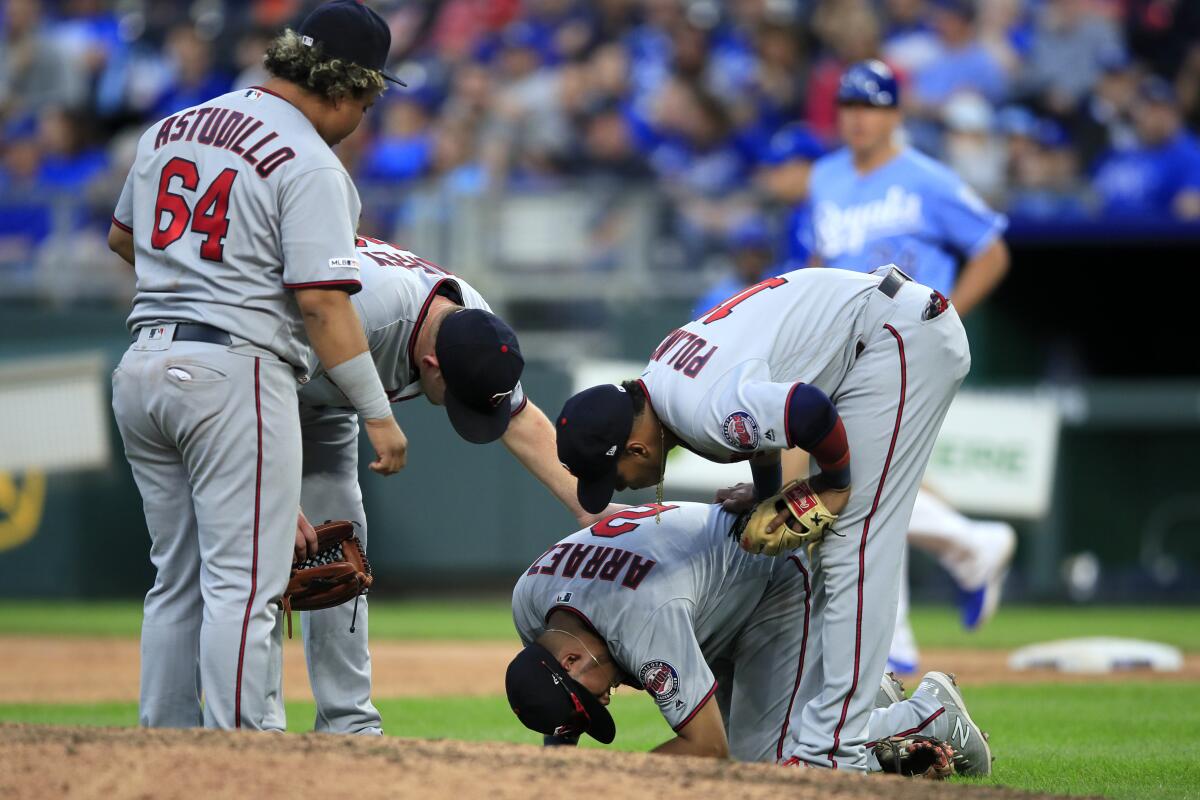 Minnesota Twins first baseman Willians Astudillo, left, is run