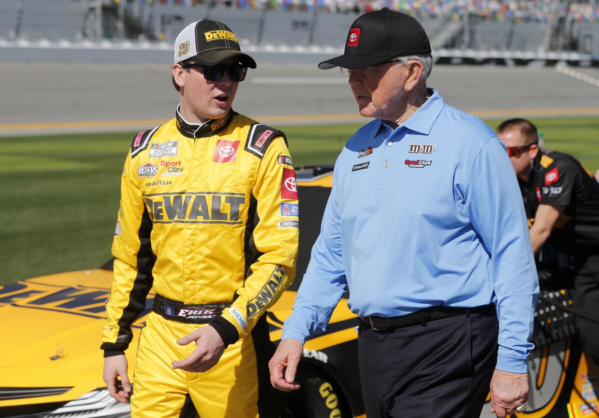 NASCAR driver Erik Jones, left, talks with team owner Joe Gibbs during qualifying the Daytona 500 on Feb. 9.