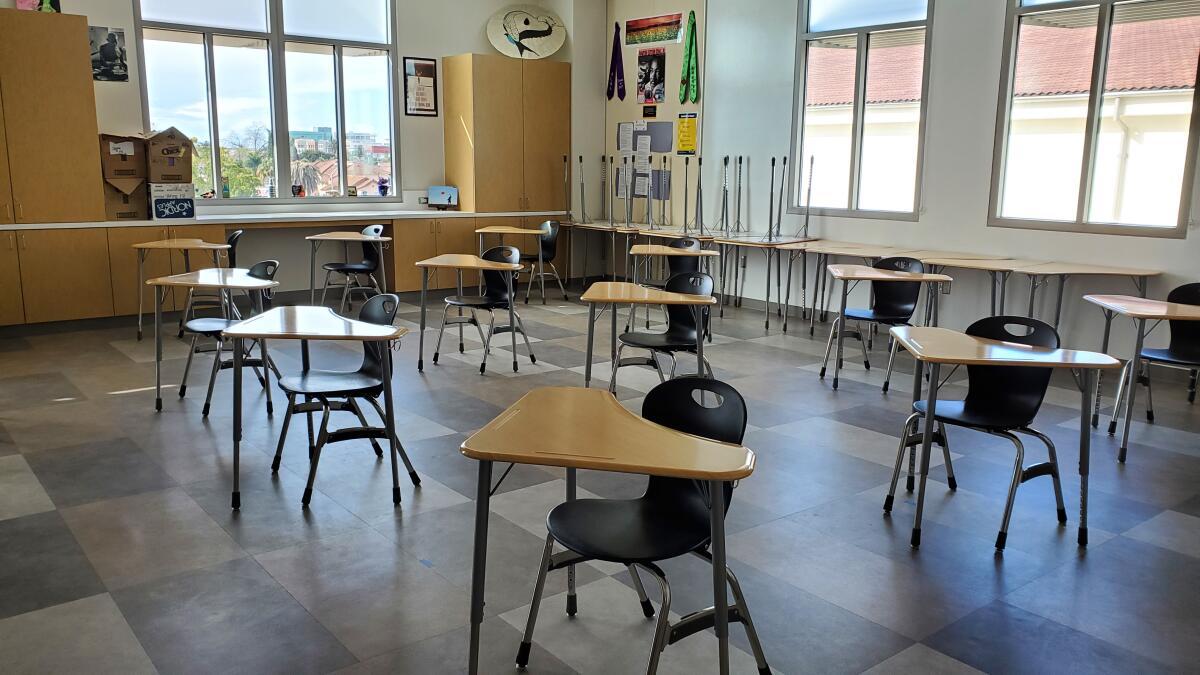 Student desks and chairs are spaced several feet apart in a classroom at newly rebuilt Hoover High School in San Diego.