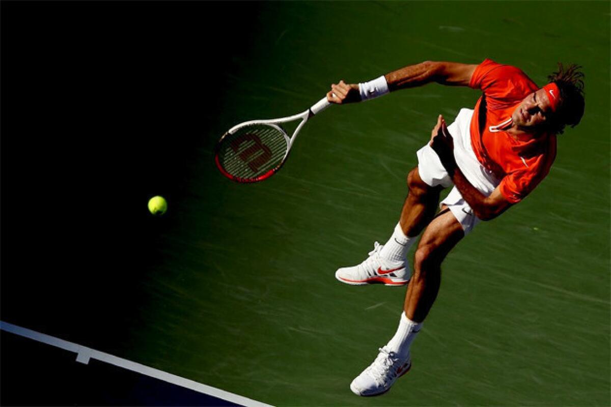 Roger Federer serves to Ivan Dodig of Croatia during the BNP Paribas Open at the Indian Wells.