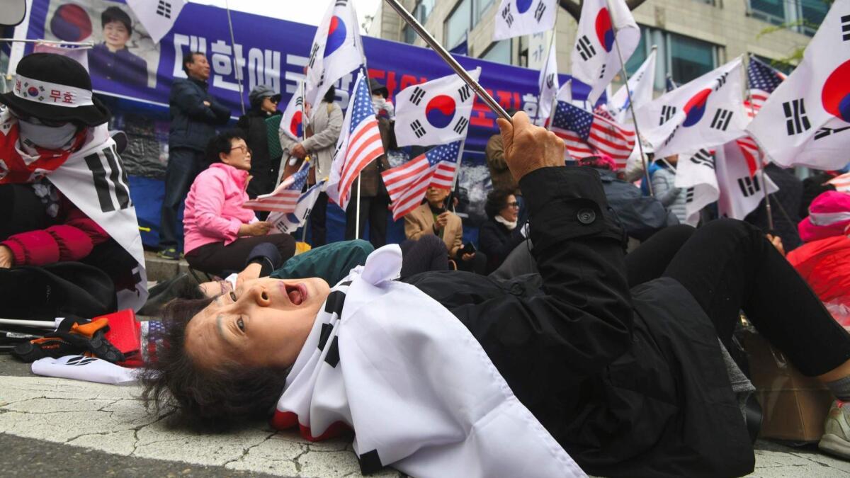 A Park supporter reacts after a court sentenced the former president to 24 years in prison.