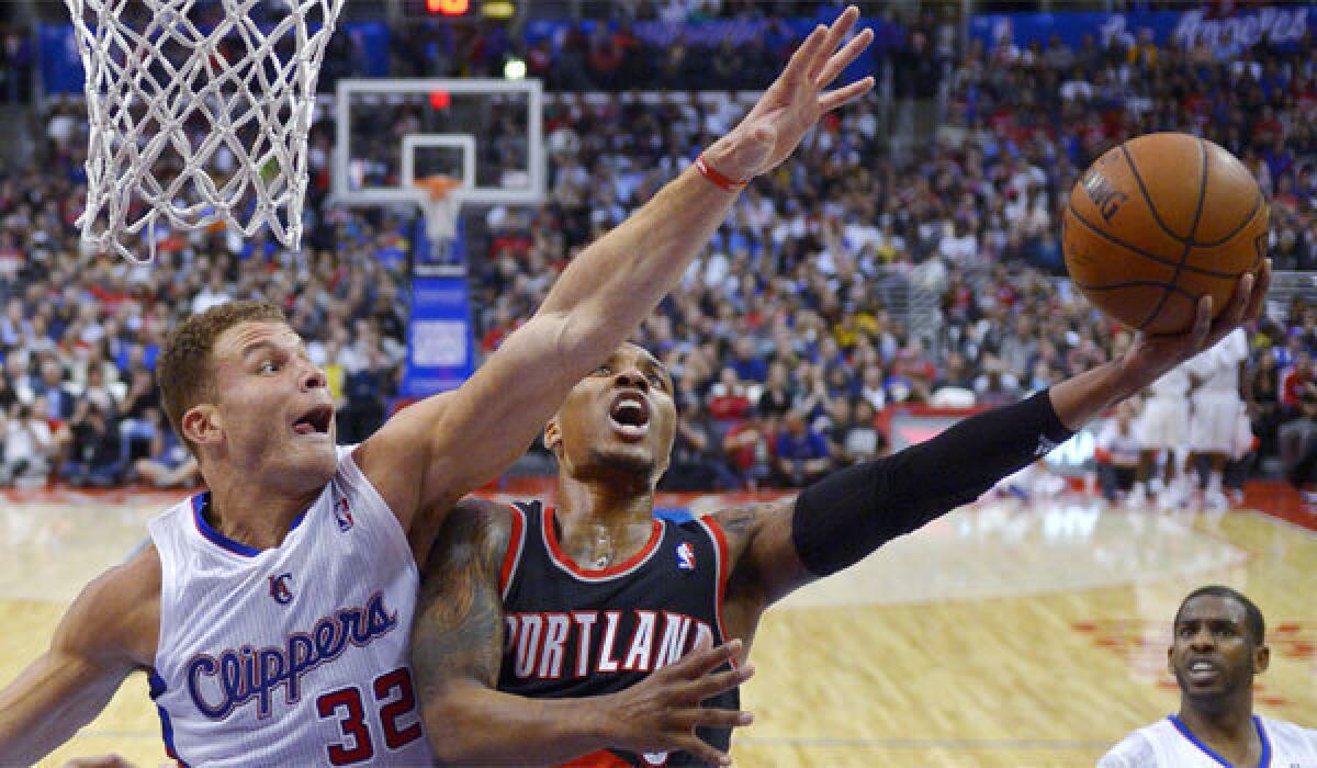 Portland guard Damian Lillard puts up a shot against Clippers forward Blake Griffin on Feb. 12 at Staples Center.