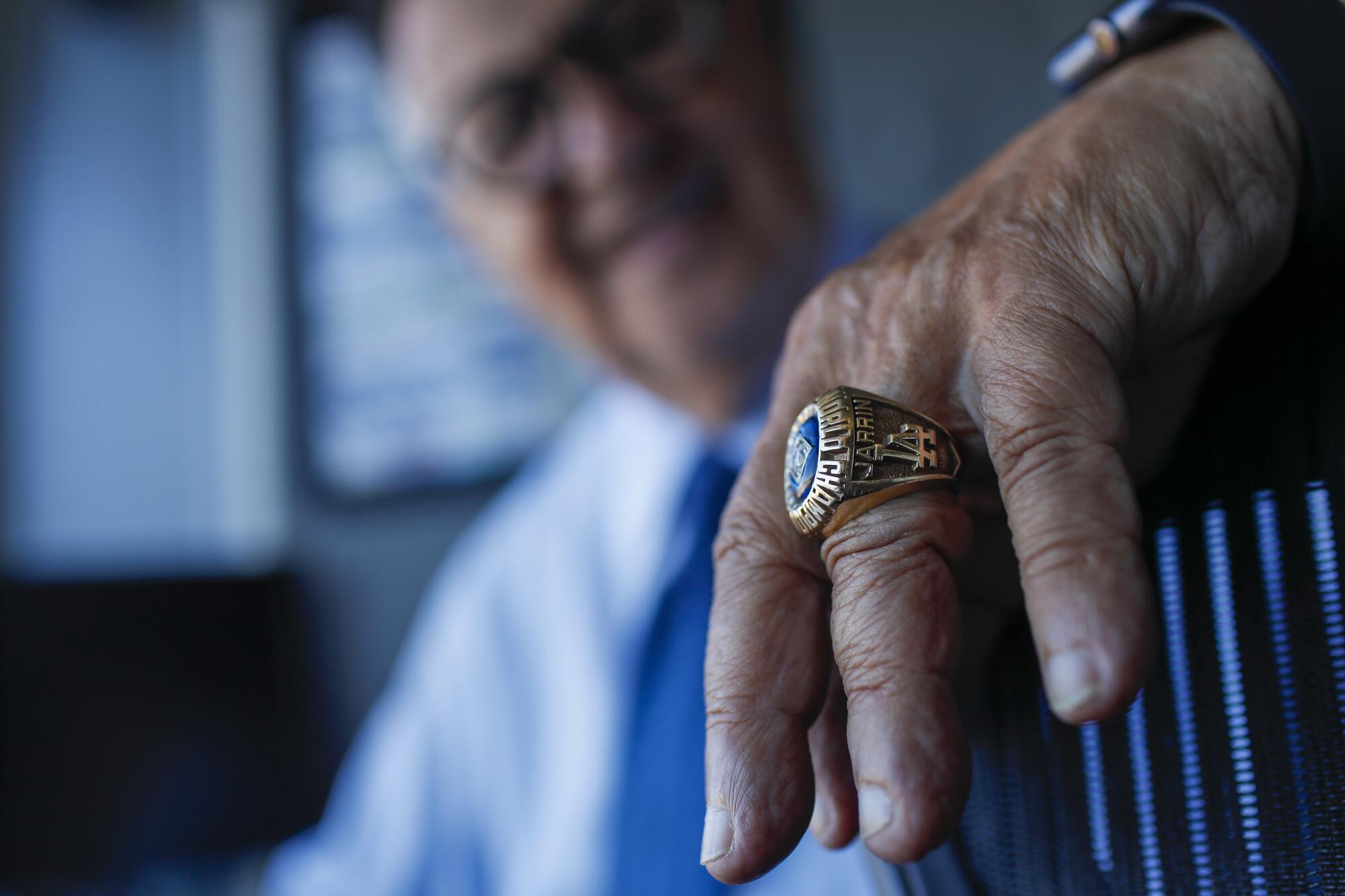 Veteran Dodgers broadcaster Jaime Jarrín displays his 1988 championship ring, a prized possession, July 7 at Dodger Stadium.