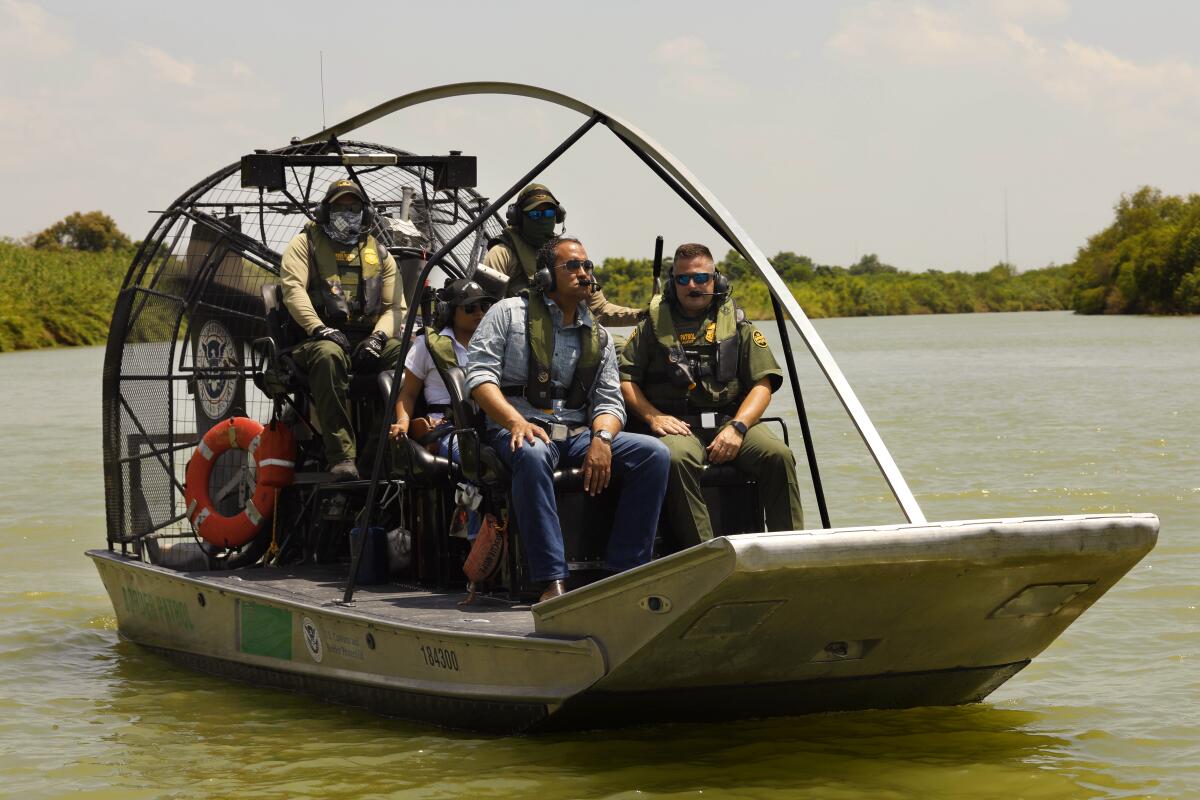 Hurd, front left, tours the Rio Grande by boat with Border Patrol agents.