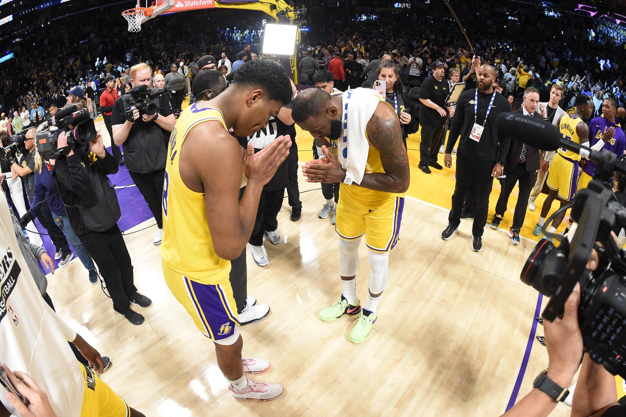 Lakers teammates Rui Hachimura, left, and LeBron James pay their respects to each other after a playoff game last season.