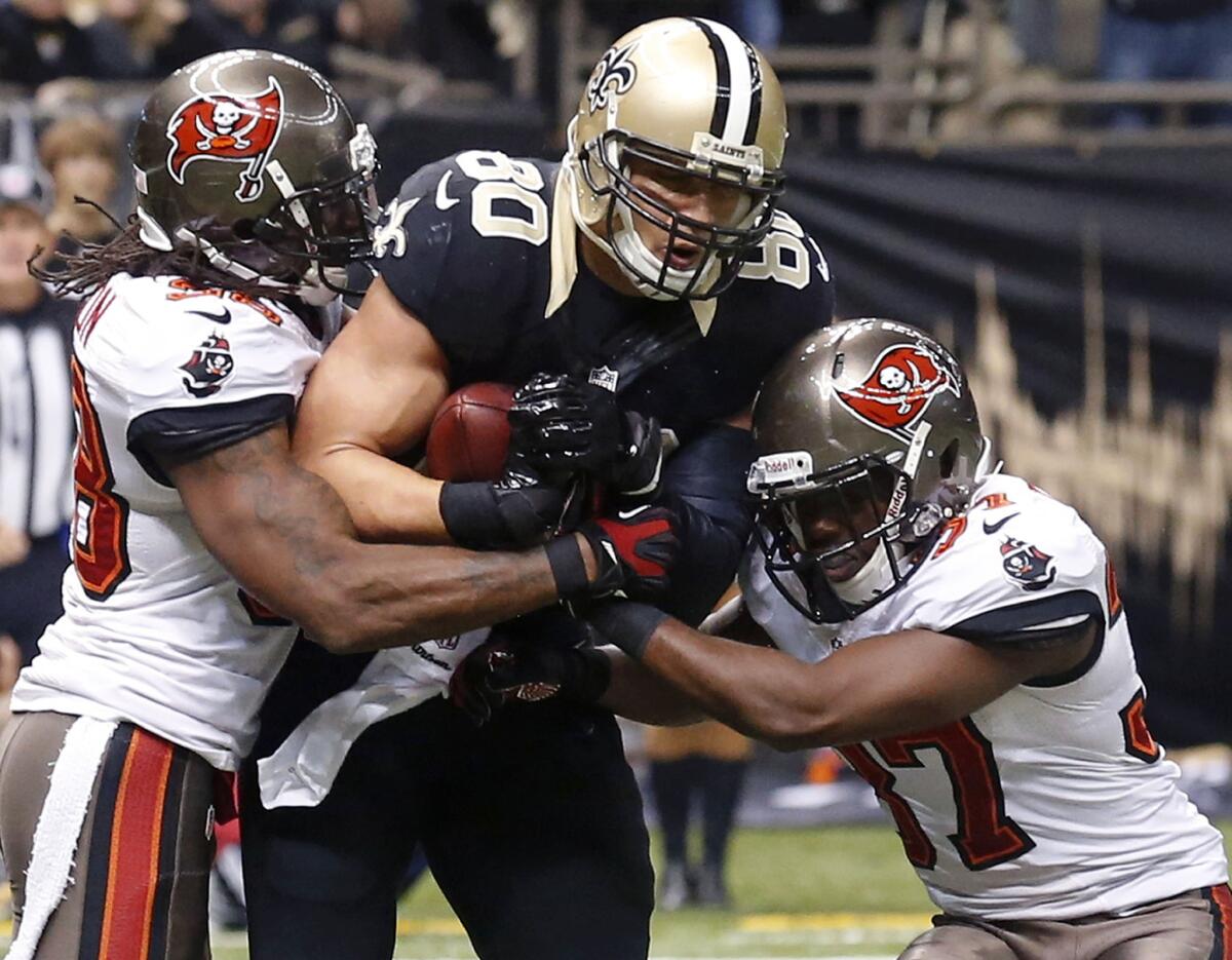 New Orleans Saints' Jimmy Graham pulls in a touchdown reception between Tampa Bay's Dashon Goldson, left, and Keith Tandy.