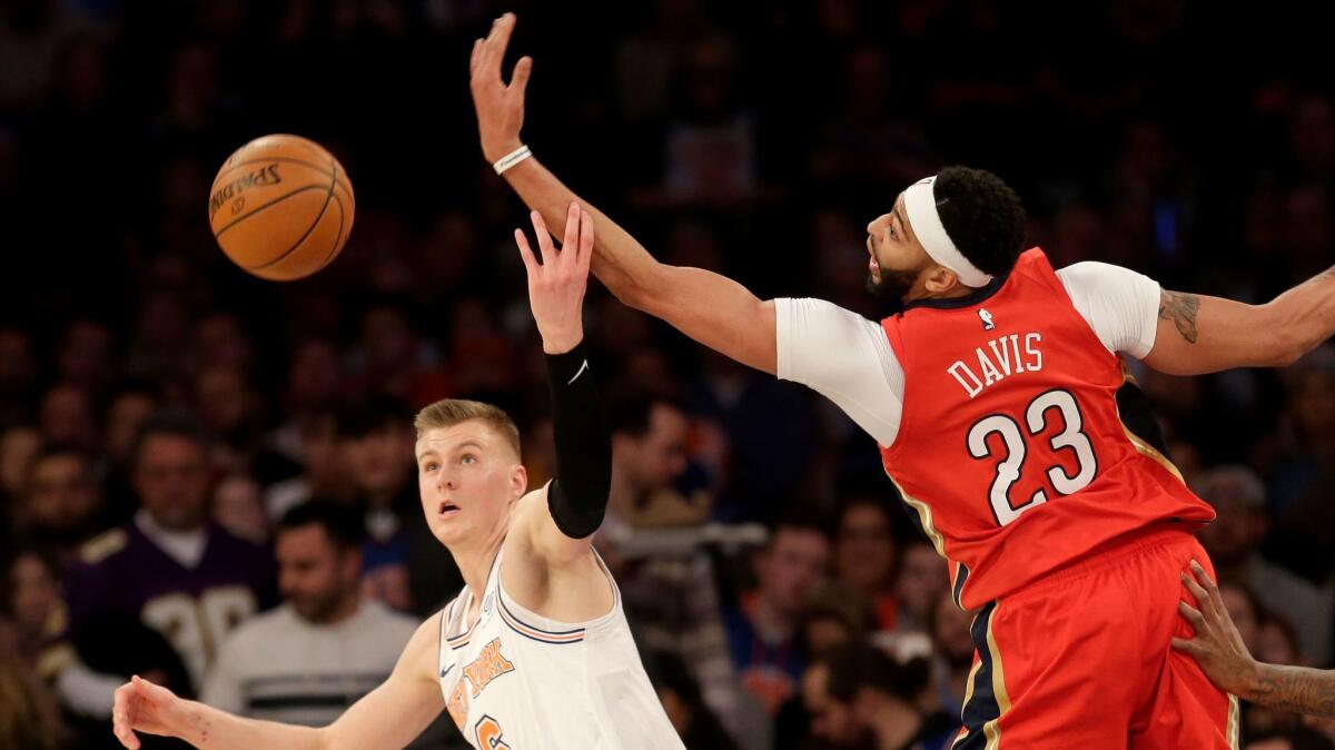New Orleans Pelicans' Anthony Davis and New York Knicks' Kristaps Porzingis fight for a rebound during the second half.